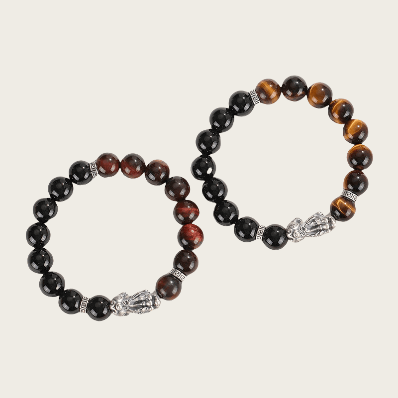 A pair of High-quality 999 sterling silver couple bracelet with black onyx , one with red tiger eye beads and the other with yellow tiger eye beads, featuring a traditional Pixiu charm – symbol of love, protection, and good fortune.